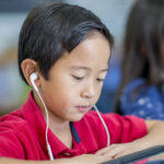 Little Boy Reading on a Tablet