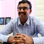 Moses Chowdari Gorrepati sits in an office at Benetech