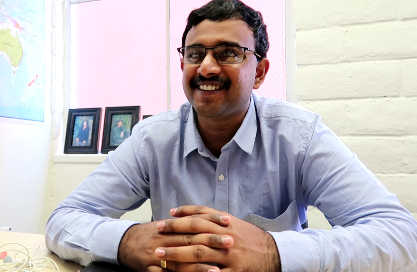 Moses Chowdari Gorrepati sits in an office at Benetech