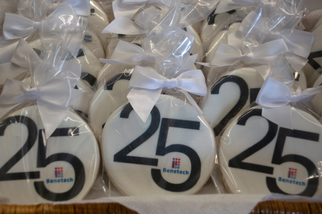 A display of individually wrapped cookies with the number "25" and the Benetech logo, celebrating the organization's anniversary.