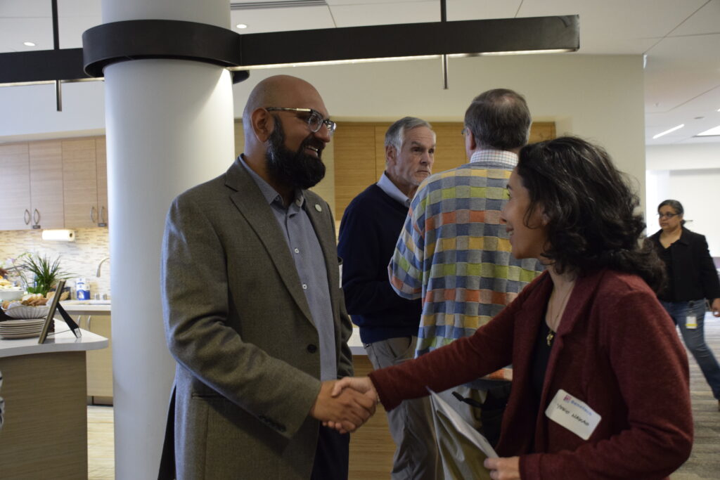 Ayan Kishore and Yoko Nakao shake hands and connect during a Benetech networking reception.