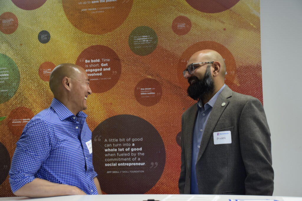Kevin Lo and Ayan Kishore share a laugh in front of an inspirational mural.